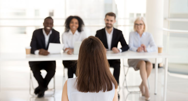 Four hiring managers interviewing a candidate