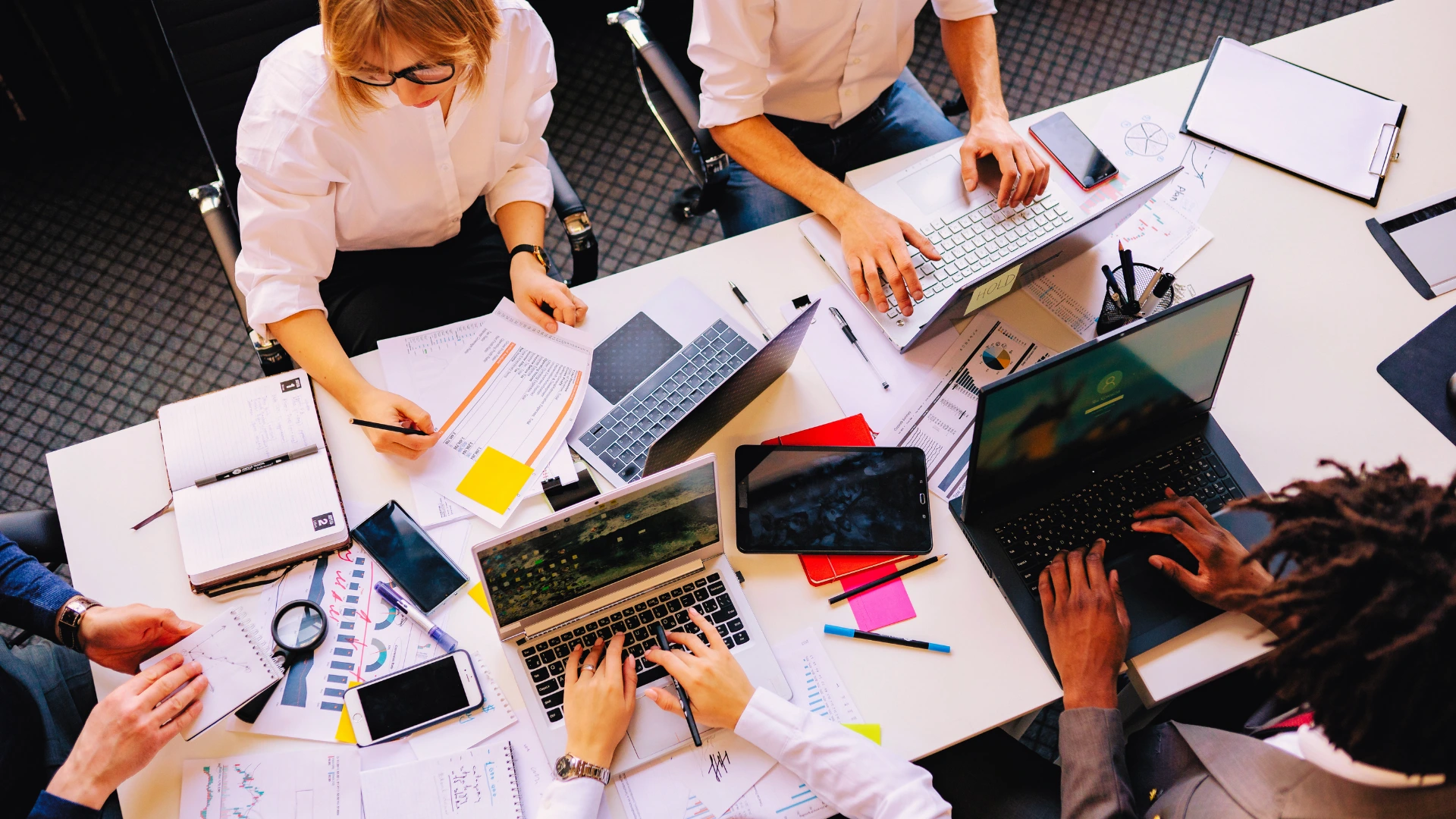 High-angle view of a diverse team collaborating around a conference table 