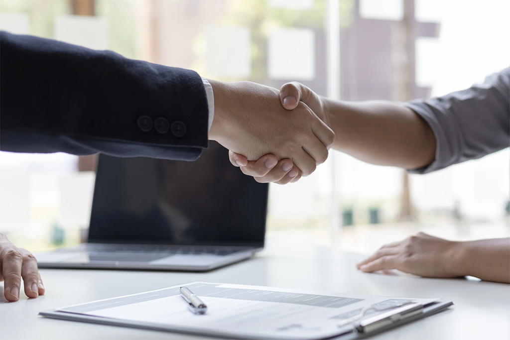Two people shaking hands after a job interview