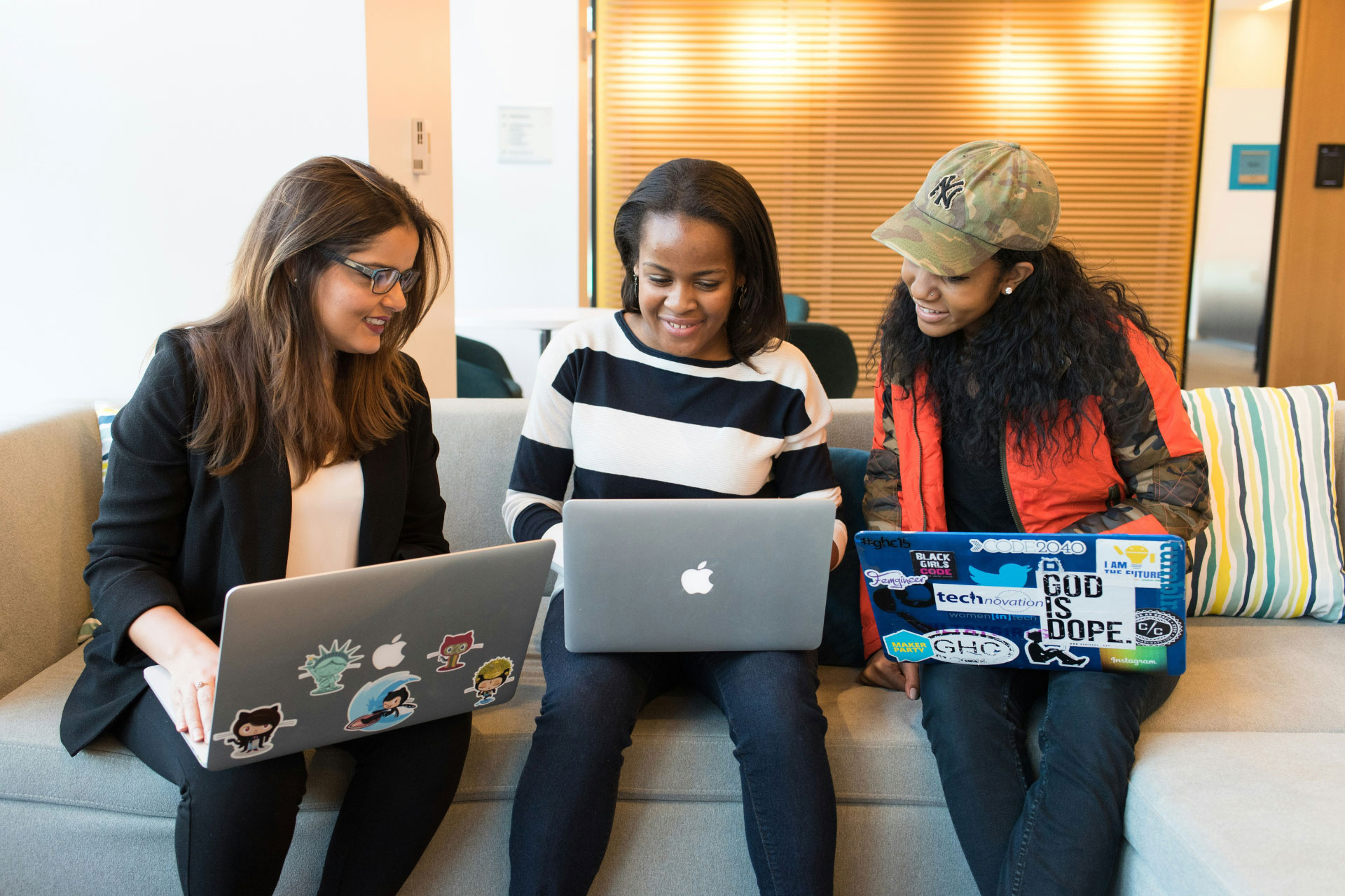 Three women working on laptops together