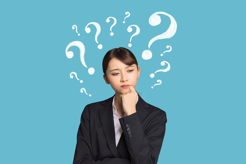 A thinking woman with question marks around her head