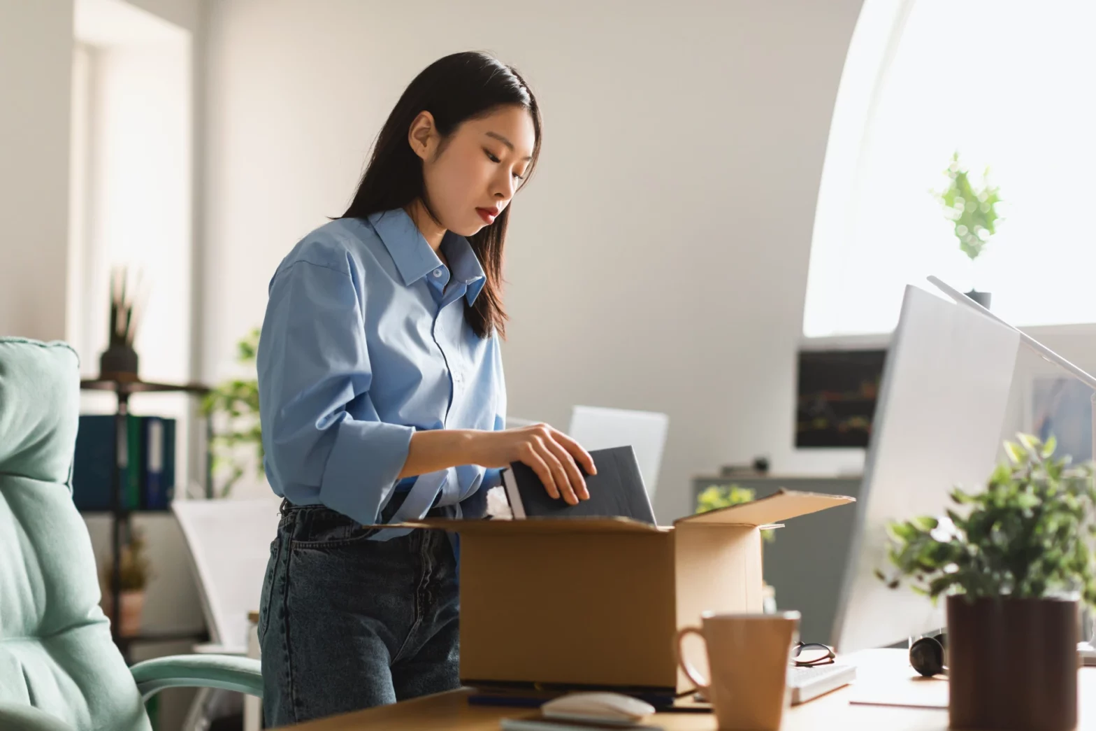 Employee putting her personal items in a box