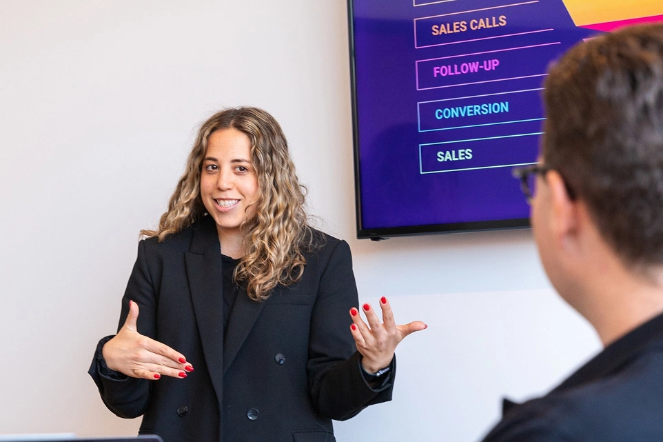 A female employee presenting in front of coworkers