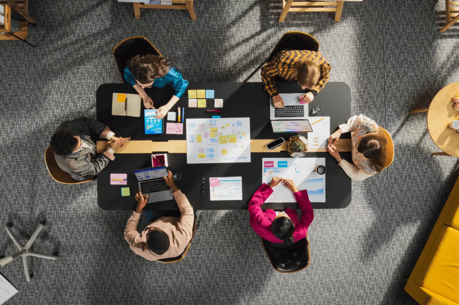Top-down view of young, diverse marketers working