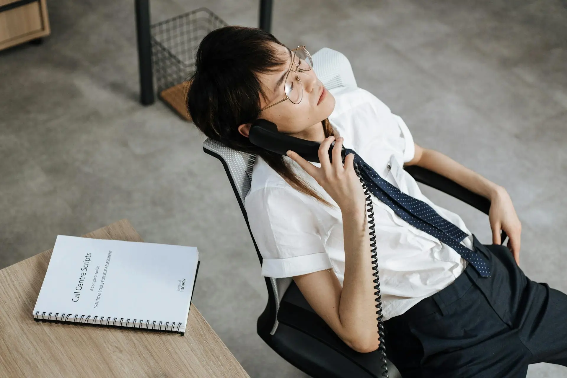 Short-haired female employee on the phone