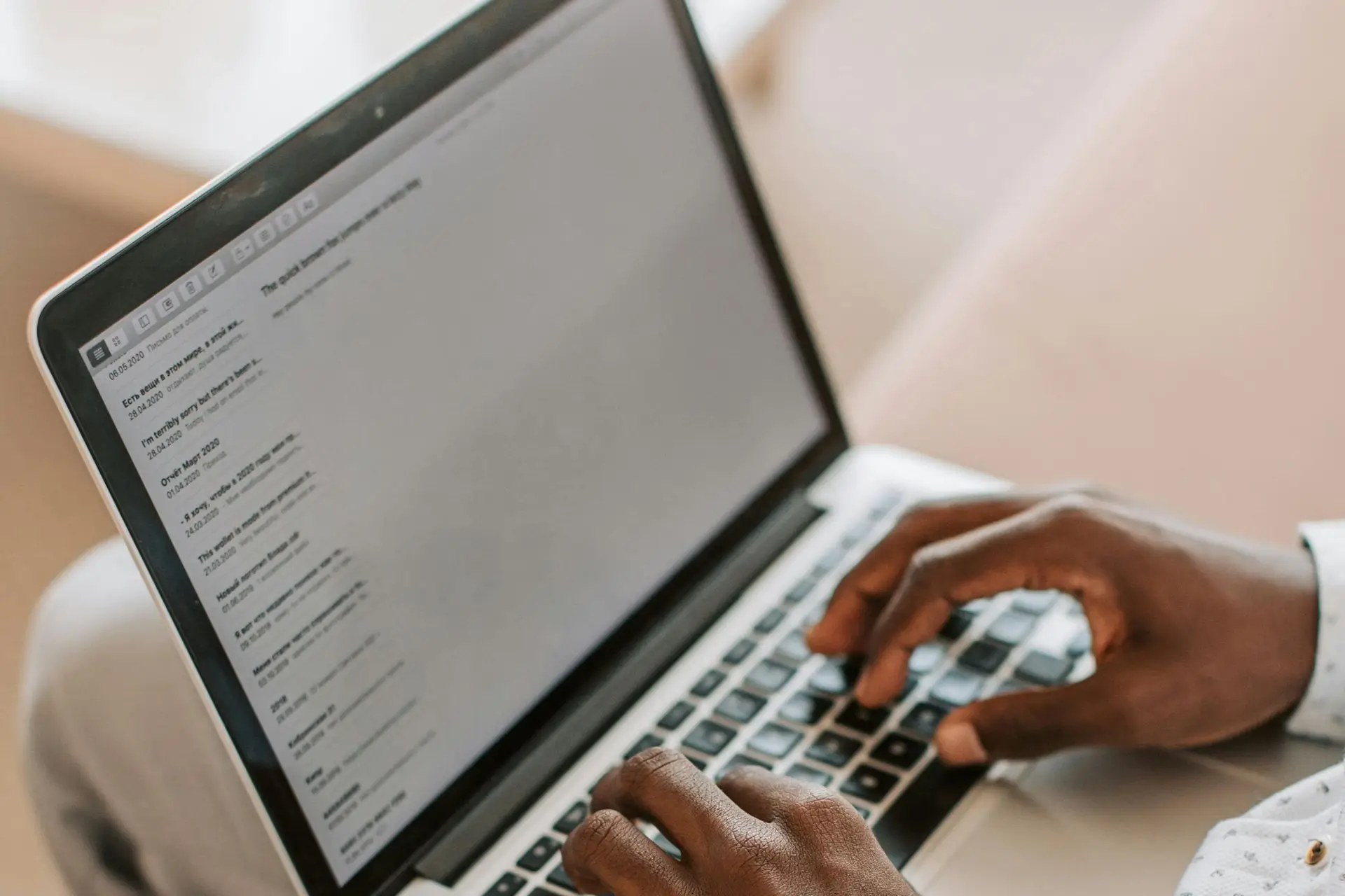 A person typing an email on a laptop