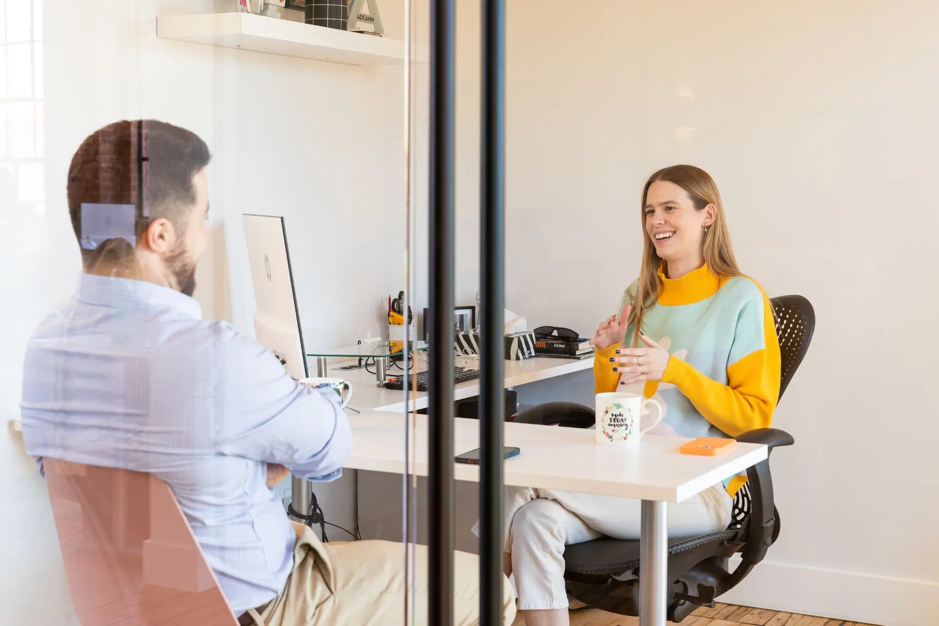 A woman in a yellow shirt smiling with a man in a blue shirt