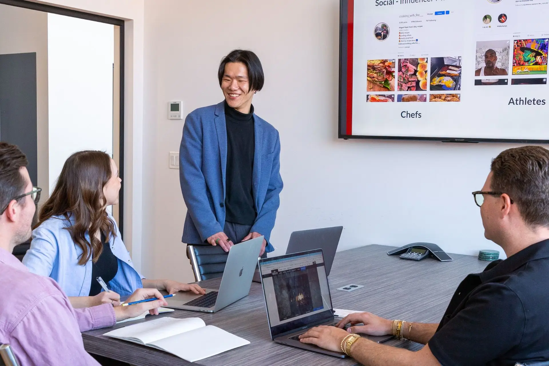 SMM leader in a blue coat leading the team meeting