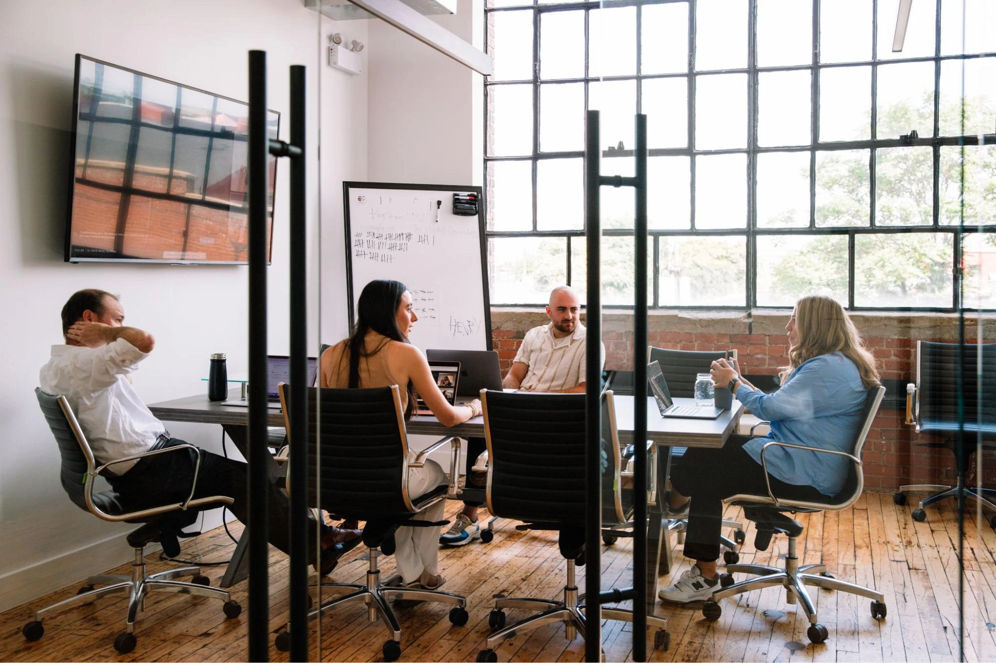 Employees in a boardroom discussing recruitment