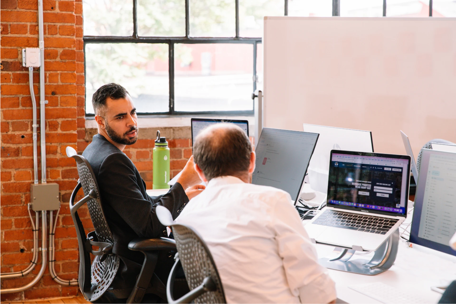 Two digital marketing managers talking in an office