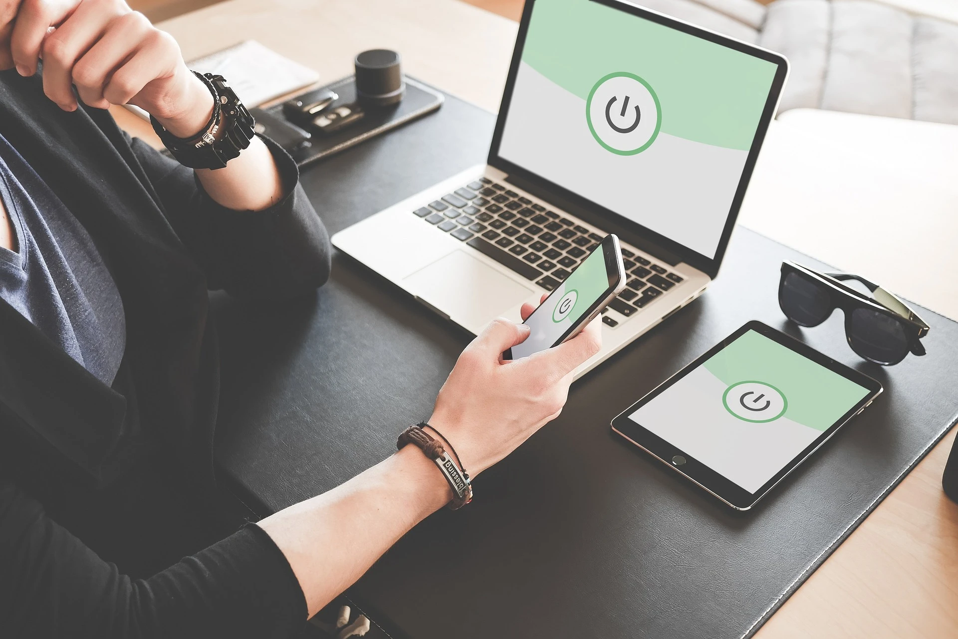 A person using cybersecurity software on all devices 